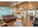 Open-concept living room featuring hardwood floors and a wood panel ceiling at 26535 Deuce Ct, Leesburg, FL 34748