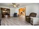 Bright living room with hard surface flooring and open concept views to other rooms at 26535 Deuce Ct, Leesburg, FL 34748