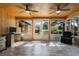 Bright and spacious sunroom features a wood ceiling with fans, hard floors, and scenic views at 26535 Deuce Ct, Leesburg, FL 34748