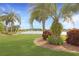 Beautiful backyard with lush lawn and pond in the distance at 27024 Old English Ct, Leesburg, FL 34748