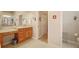 Bright bathroom features a vanity area with drawers and storage, plus a separate toilet at 27024 Old English Ct, Leesburg, FL 34748