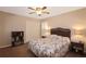 Inviting bedroom with a wicker headboard, ceiling fan, and double closet doors at 27024 Old English Ct, Leesburg, FL 34748