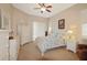 Bright bedroom with light colored walls, white furniture, and a ceiling fan at 27024 Old English Ct, Leesburg, FL 34748