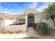 Close-up of an inviting home entrance, featuring a decorative door and landscaped surroundings at 27024 Old English Ct, Leesburg, FL 34748