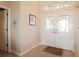 Bright foyer showcasing tiled floors, a decorative double-door entrance, and neutral paint at 27024 Old English Ct, Leesburg, FL 34748