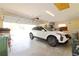 Two car garage with a white Cadillac parked inside at 27024 Old English Ct, Leesburg, FL 34748