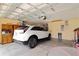 Spacious garage features modern car, ample storage, and functional layout at 27024 Old English Ct, Leesburg, FL 34748