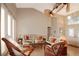 Open living area featuring tiled floors, wicker furniture, and large windows at 27024 Old English Ct, Leesburg, FL 34748