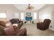 Spacious living room with comfortable leather seating and a large entertainment center at 27024 Old English Ct, Leesburg, FL 34748