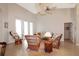 Relaxing living room with wicker furnishings, neutral colors, and a ceiling fan at 27024 Old English Ct, Leesburg, FL 34748