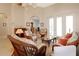Inviting living room featuring wicker furniture, tiled floors, and arched doorways at 27024 Old English Ct, Leesburg, FL 34748