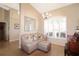 Comfortable living room with tile floors, a plush sofa, and bright natural light at 27024 Old English Ct, Leesburg, FL 34748