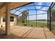View from the screened-in patio to a pond and yard at 27024 Old English Ct, Leesburg, FL 34748