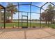 Spacious screened-in patio overlooking serene pond with mature trees at 27024 Old English Ct, Leesburg, FL 34748