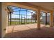 Screened-in patio featuring brick pavers and stunning views of the adjacent pond at 27024 Old English Ct, Leesburg, FL 34748
