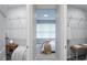 Bright bedroom boasts a walk-in closet with wire shelving and a cozy nook, creating an organized, inviting space at 2749 Hilltop Rd, Clermont, FL 34711