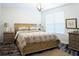 Comfortable bedroom with floral bedding, bedside tables, and warm lamps, creating a relaxing atmosphere at 2749 Hilltop Rd, Clermont, FL 34711