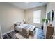 Bright bedroom has wood floors, bench and plenty of plants, blending natural elements with refined styling at 2749 Hilltop Rd, Clermont, FL 34711