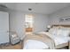 Comfortable bedroom with an adjoining bathroom, with neutral tones and wood grain flooring, offers a peaceful retreat at 2749 Hilltop Rd, Clermont, FL 34711