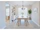 Bright dining room with a modern chandelier, natural light, and open space for gatherings at 2749 Hilltop Rd, Clermont, FL 34711