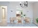 Elegant dining room featuring a wooden table set for four, and chandelier lighting at 2749 Hilltop Rd, Clermont, FL 34711