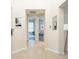 Bright hallway with tiled floors, neutral walls, and views into the bedrooms and other living spaces at 2749 Hilltop Rd, Clermont, FL 34711