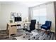 Bright home office space featuring a modern desk, stylish chair, and decorative artwork at 2749 Hilltop Rd, Clermont, FL 34711