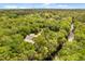 Beautiful aerial shot showcasing a home nestled in dense trees with a river nearby at 2870 Belinda Dr, Deland, FL 32720