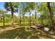 Backyard scene with wooded landscape, dock, and open grass at 2870 Belinda Dr, Deland, FL 32720