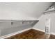 Attic closet featuring built-in shelving and hardwood floors for storage and organization at 2870 Belinda Dr, Deland, FL 32720