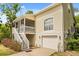 Charming two-story home with a screened porch, white railings, and a one-car garage at 2870 Belinda Dr, Deland, FL 32720