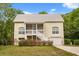 Charming two-story home with a screened porch, white railings, and a one-car garage at 2870 Belinda Dr, Deland, FL 32720