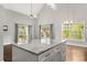 Spacious kitchen with a large marble island, elegant lighting, and views of the trees at 2870 Belinda Dr, Deland, FL 32720