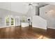 Open-concept living area with hardwood floors, white cabinets, modern appliances, and lots of sunlight at 2870 Belinda Dr, Deland, FL 32720