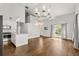 Spacious living room with hardwood floors, a kitchen, and a staircase leading to the second floor at 2870 Belinda Dr, Deland, FL 32720