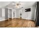 Bright main bedroom with hardwood floors, ceiling fan, and open doorway to bathroom at 2870 Belinda Dr, Deland, FL 32720