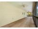Spacious screened-in porch with wood flooring and ceiling fans, perfect for outdoor enjoyment at 2870 Belinda Dr, Deland, FL 32720