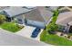 Aerial shot of the home showcasing the lush landscaping, expansive driveway, and overall curb appeal at 2992 Hicks Pl, The Villages, FL 32163