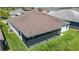 An aerial shot reveals the home's roof, siding, backyard, and screened patio at 2992 Hicks Pl, The Villages, FL 32163