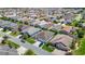 An aerial view of homes showcasing their lush landscaping and two-car garages, nestled in a vibrant community at 2992 Hicks Pl, The Villages, FL 32163