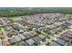 An aerial view features a community with single-Gathering homes with mature landscaping and plenty of green space at 2992 Hicks Pl, The Villages, FL 32163