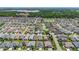 A high aerial view of a community with lush landscaping, mature trees, and waterfront properties at 2992 Hicks Pl, The Villages, FL 32163