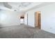 Bedroom featuring plush carpets, a ceiling fan, and doorway to an adjacent room at 2992 Hicks Pl, The Villages, FL 32163