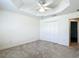 Bedroom featuring plush carpets, a ceiling fan, and closet at 2992 Hicks Pl, The Villages, FL 32163