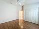 Bright bedroom featuring light hardwood floors, a ceiling fan, and a closet at 2992 Hicks Pl, The Villages, FL 32163