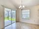 Bright dining area with sliding glass doors leading to the screened lanai and backyard at 2992 Hicks Pl, The Villages, FL 32163