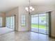 Bright dining room with tile floors, chandelier, and sliding glass doors to the outside patio at 2992 Hicks Pl, The Villages, FL 32163