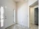 Inviting entryway with a white front door and tile flooring, leading into the home's interior at 2992 Hicks Pl, The Villages, FL 32163