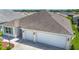 Aerial view of home featuring a spacious two-car garage and a driveway at 2992 Hicks Pl, The Villages, FL 32163