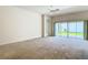 Bright living room with large sliding glass doors providing access to the backyard and natural light at 2992 Hicks Pl, The Villages, FL 32163